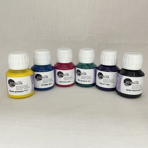 Six small bottles of Arasilk silk paint.  Colours are primary yellow cyan, magenta, malachite, violet, black