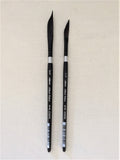 Two black paintbrushes with silver ferrules on a beige background