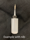 White ink bottle with a metal nib on a black textured background