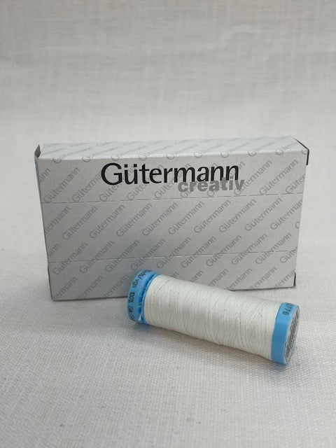 Gutermann thread spool on a branded thread roll packaging