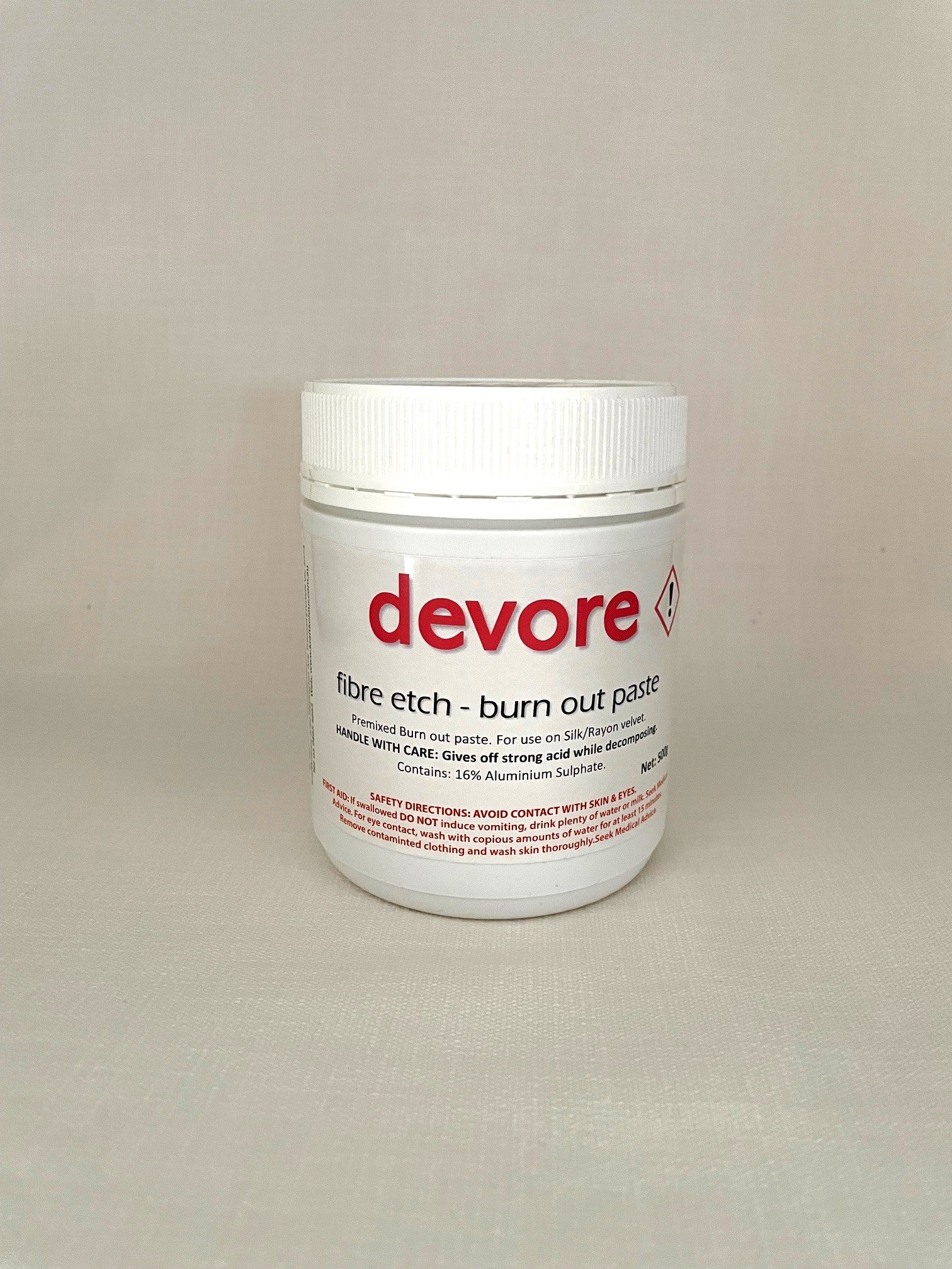 Devore fibre etch burn out paste container on a beige background