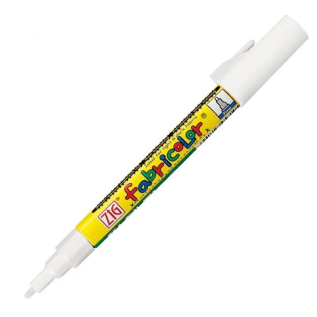 A white ZIG Fabricolor marker with a yellow and green label, shown diagonally on a plain white background.