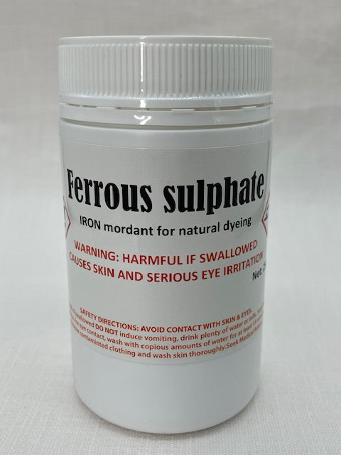 Container labeled 'Ferrous Sulphate' with warning text on a white background
