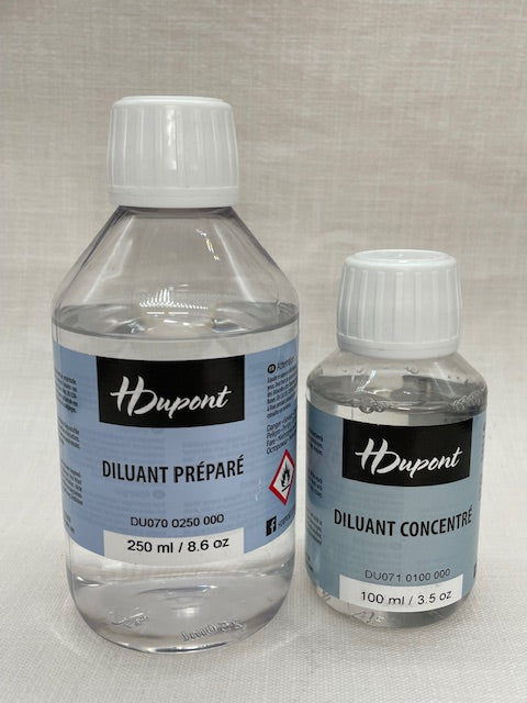Two bottles of H Dupont diluents on a light gray background