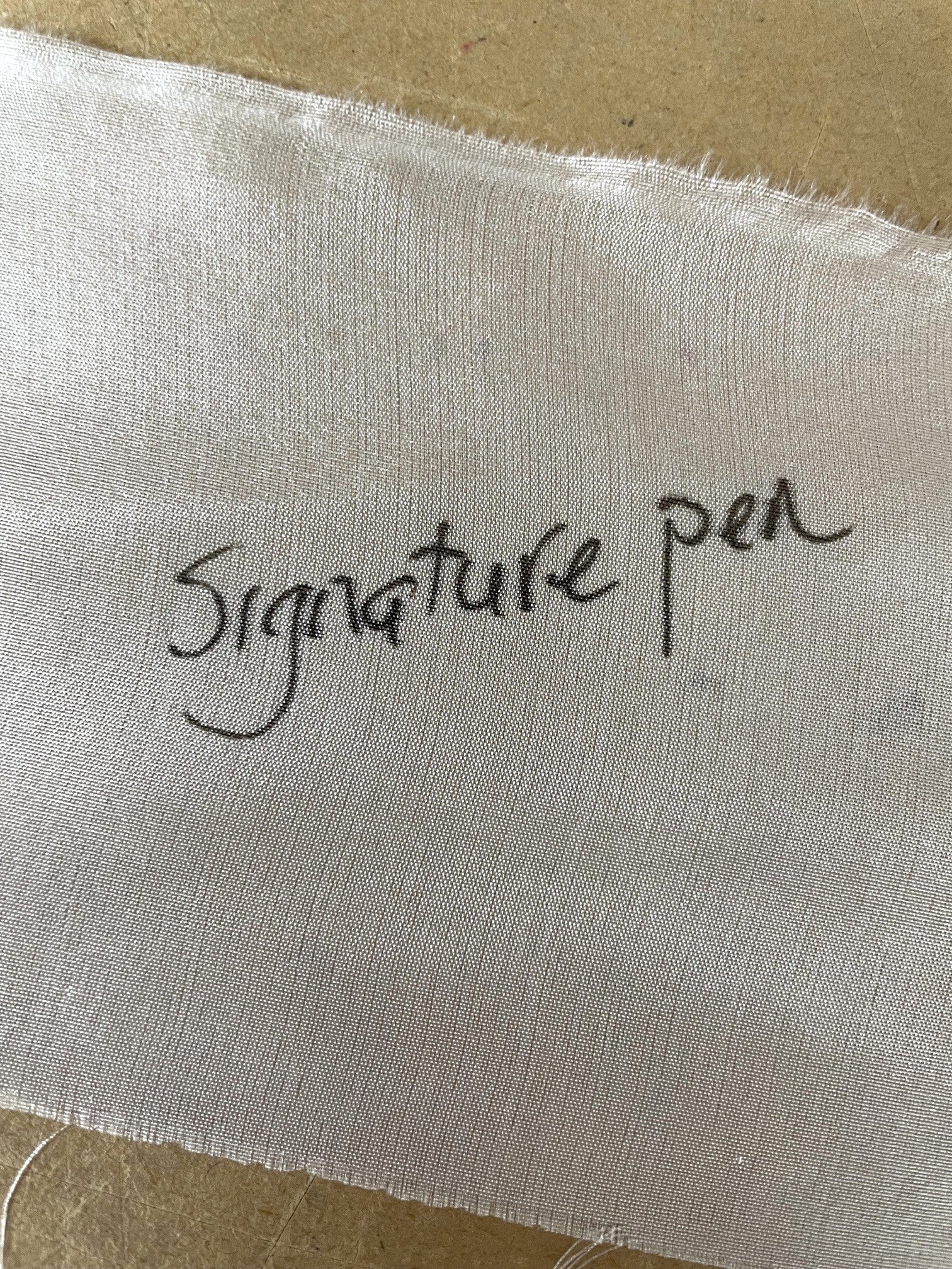 silk with writing on it on a brown background
