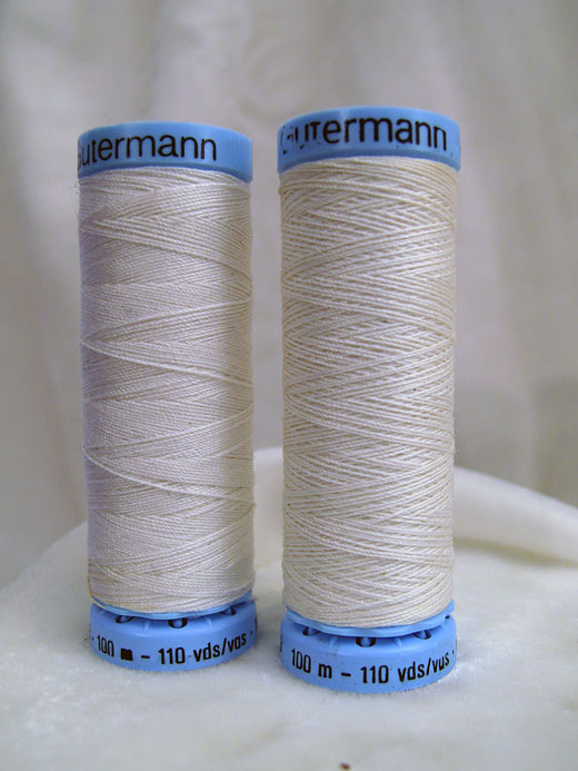 Two spools of Gutermann thread on a white background