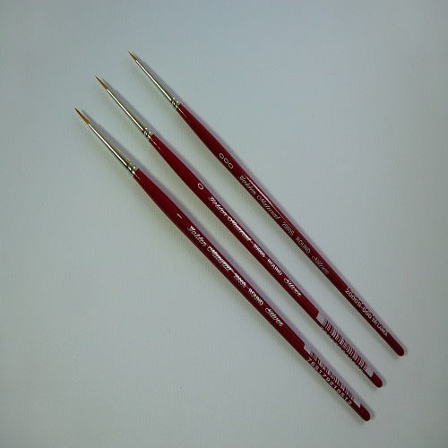 Three red paint brushes with gold ferrules on a white background