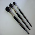 Three oval sky wash brushes with black bristles on a white background