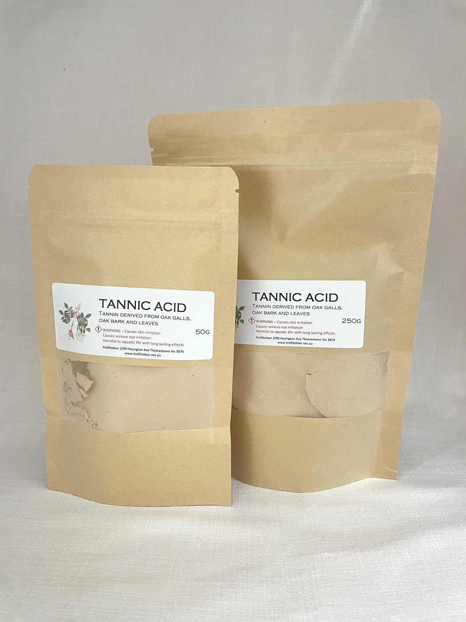 Two stand-up kraft paper pouches of Tannic Acid product, one 50g and one 250g, with white labels, set against a neutral light gray background.