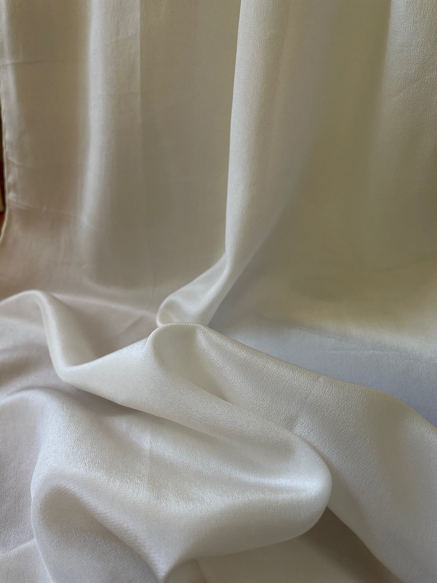 Close-up of  undyed crepe de chine white scarf with folds