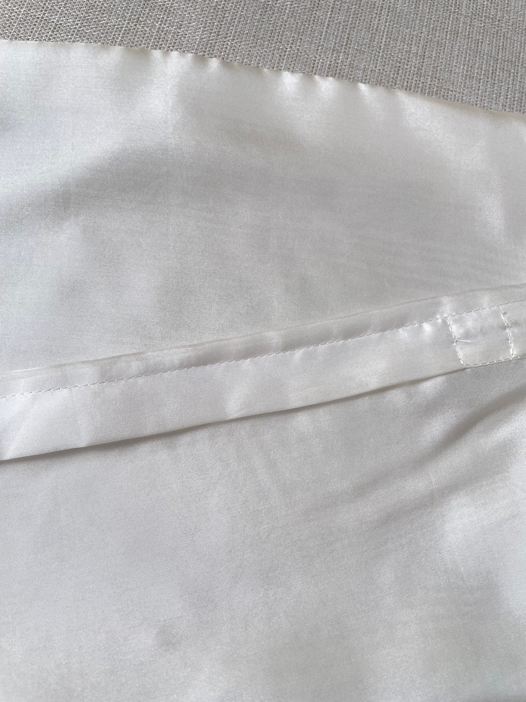Close-up of Undyed Habutai cushion cover zip closure with a subtle pattern