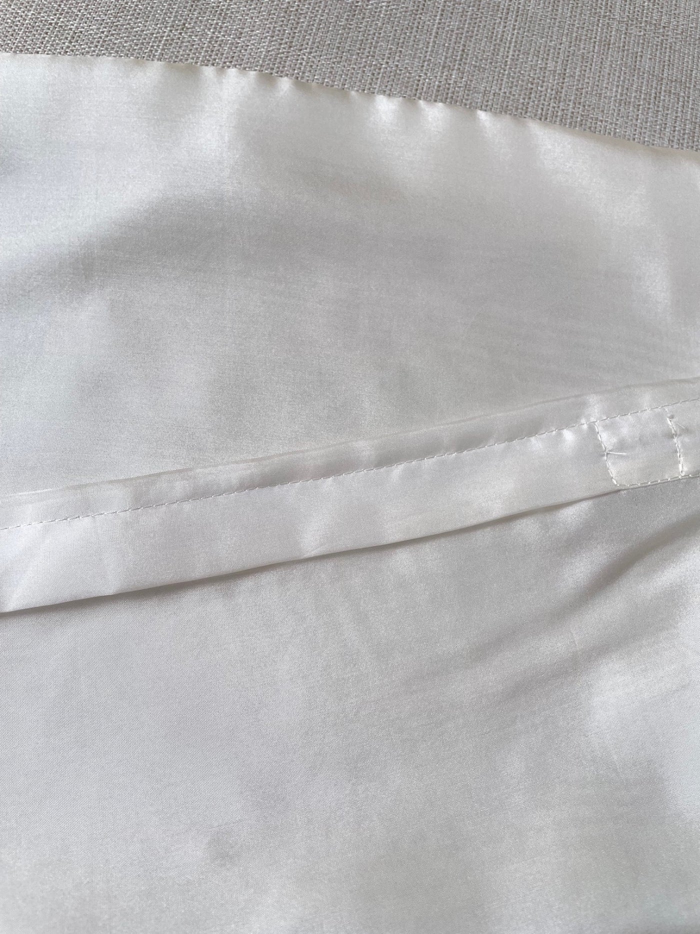 Close-up of Undyed Habutai cushion cover zip closure with a subtle pattern