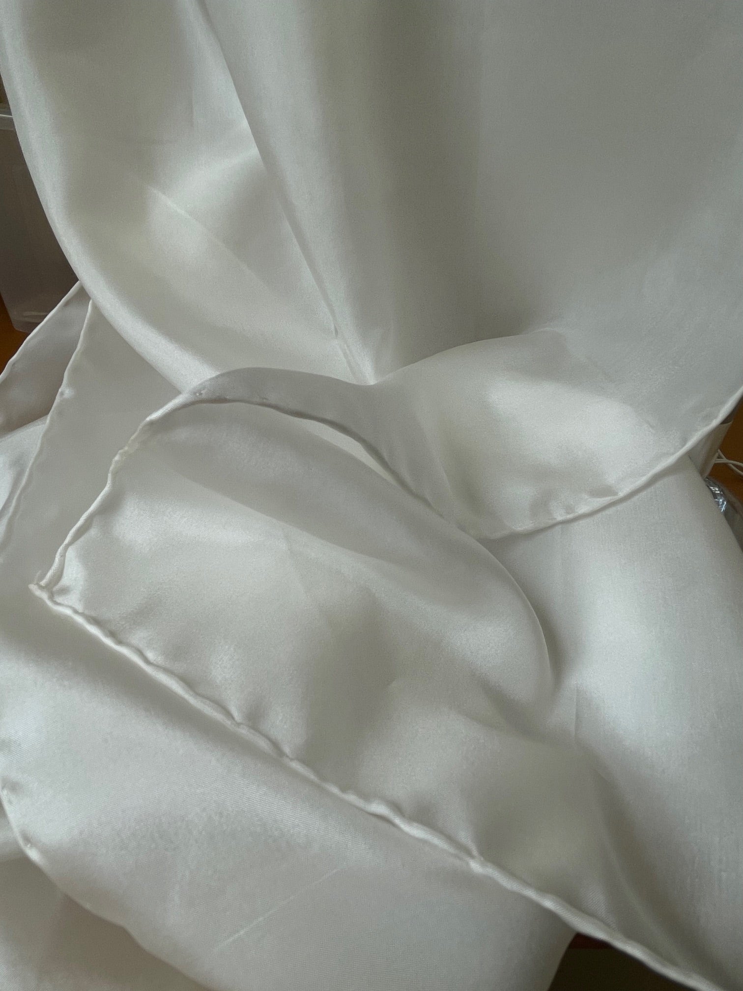 Close-up of undyed white Habutai silk scarf  with folds