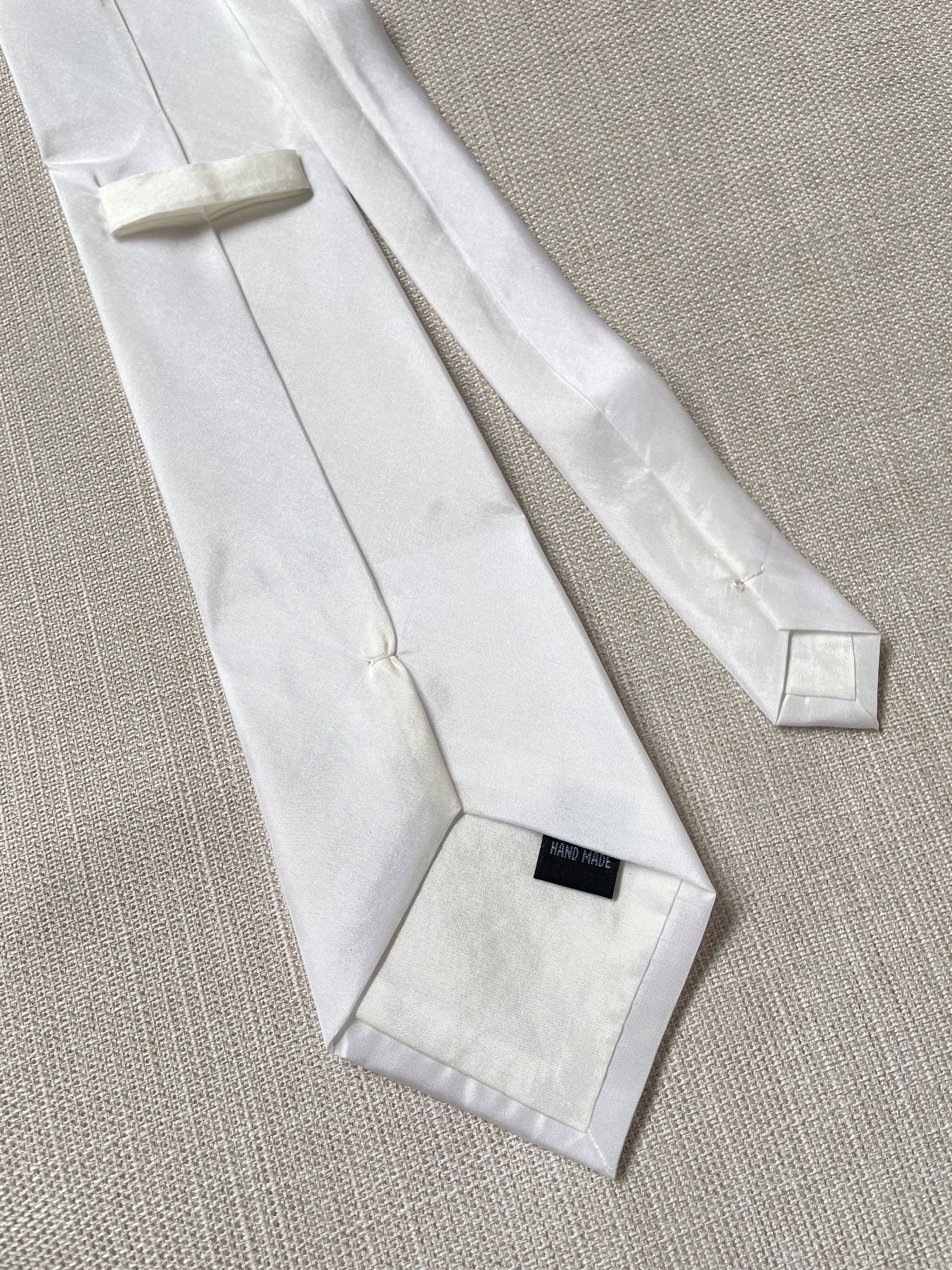 Undyed Habutai silk tie back view on a textured beige surface
