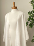 Undyed Kimono style jacket draped on a mannequin with a plant in the background