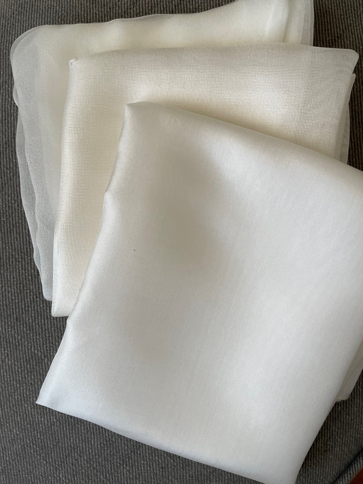 Folded white fabric on a textured gray surface