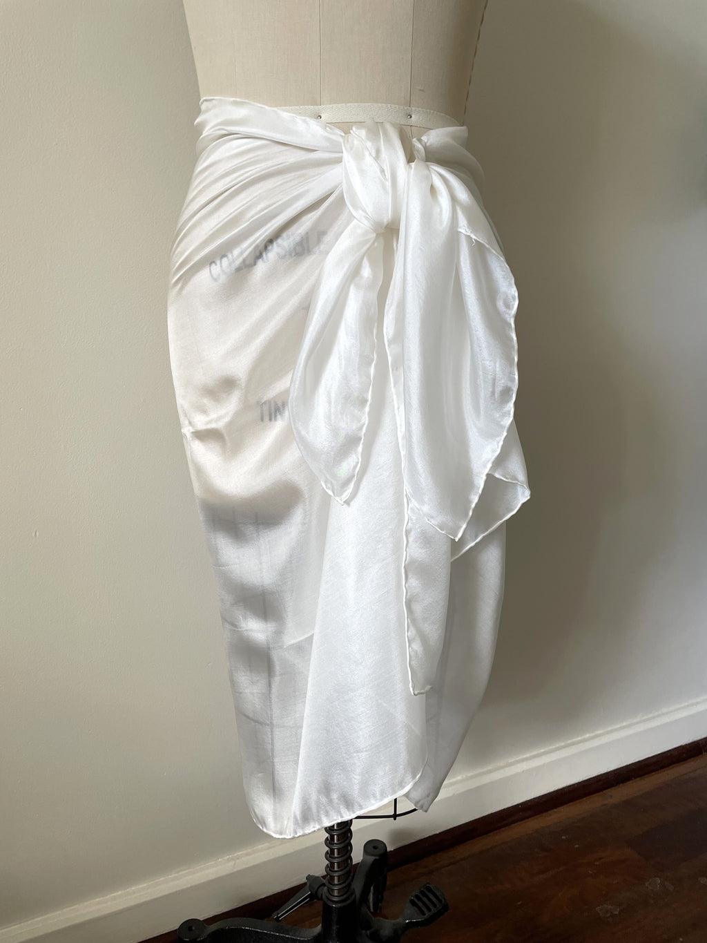 Undyed Paj silk sarong skirt on a mannequin against a plain background
