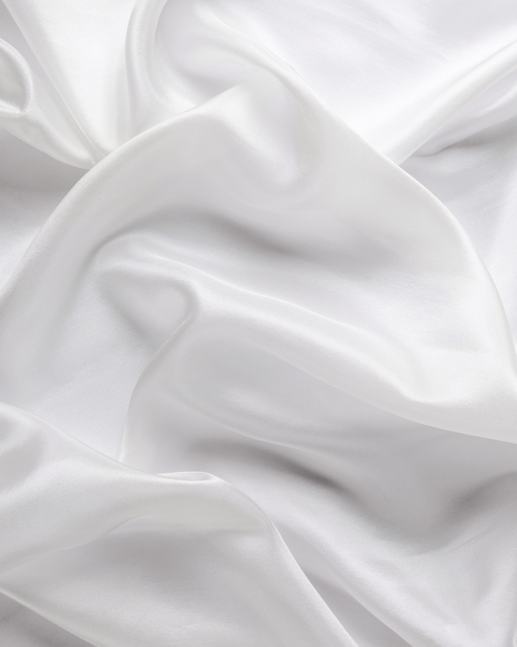 Close-up of undyed white Paj silk fabric with soft folds