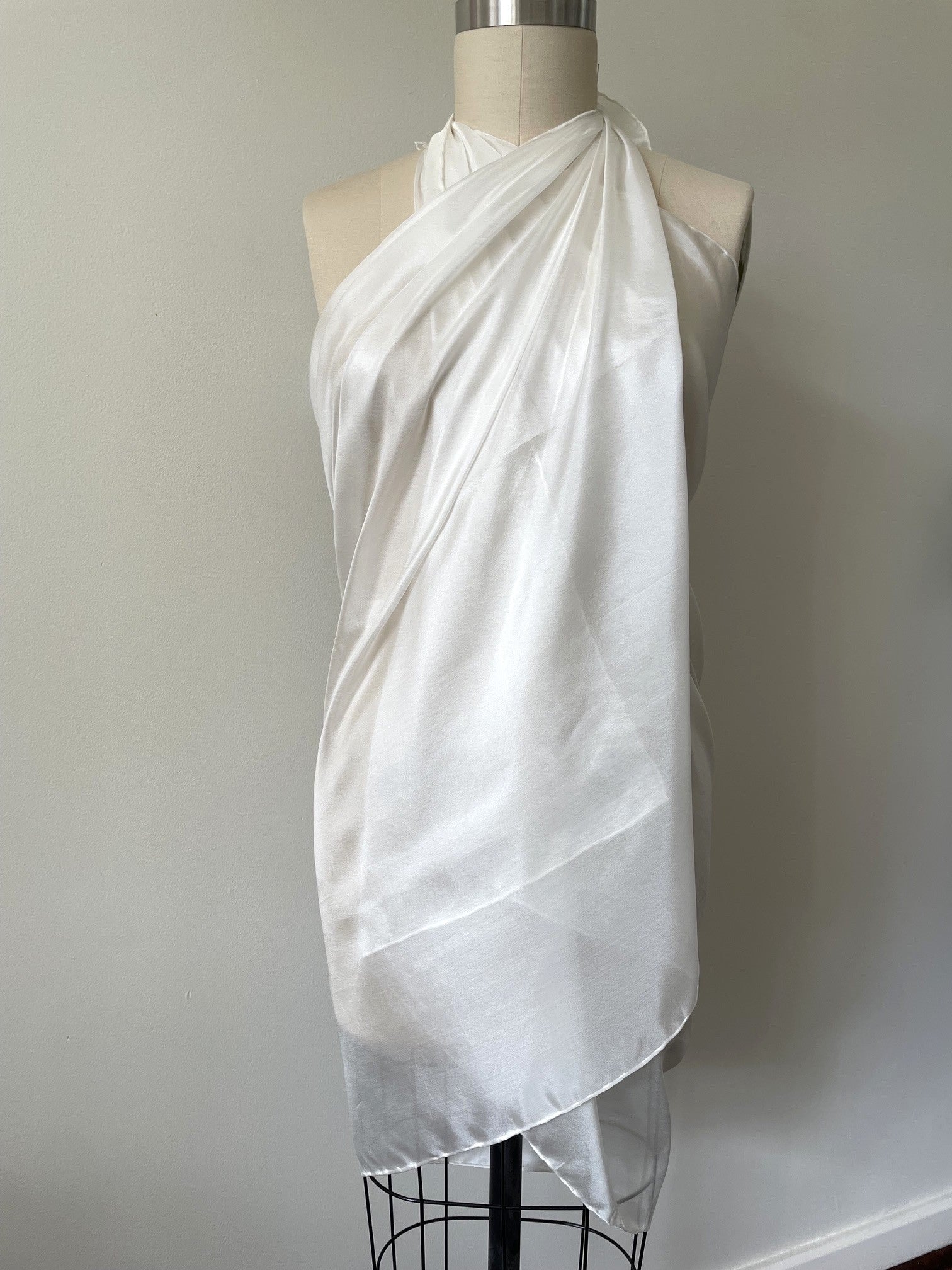 Undyed Paj silk sarong draped over a mannequin on a plain background