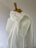 Undyed white Paj silk scarf draped over a mannequin against a plain background