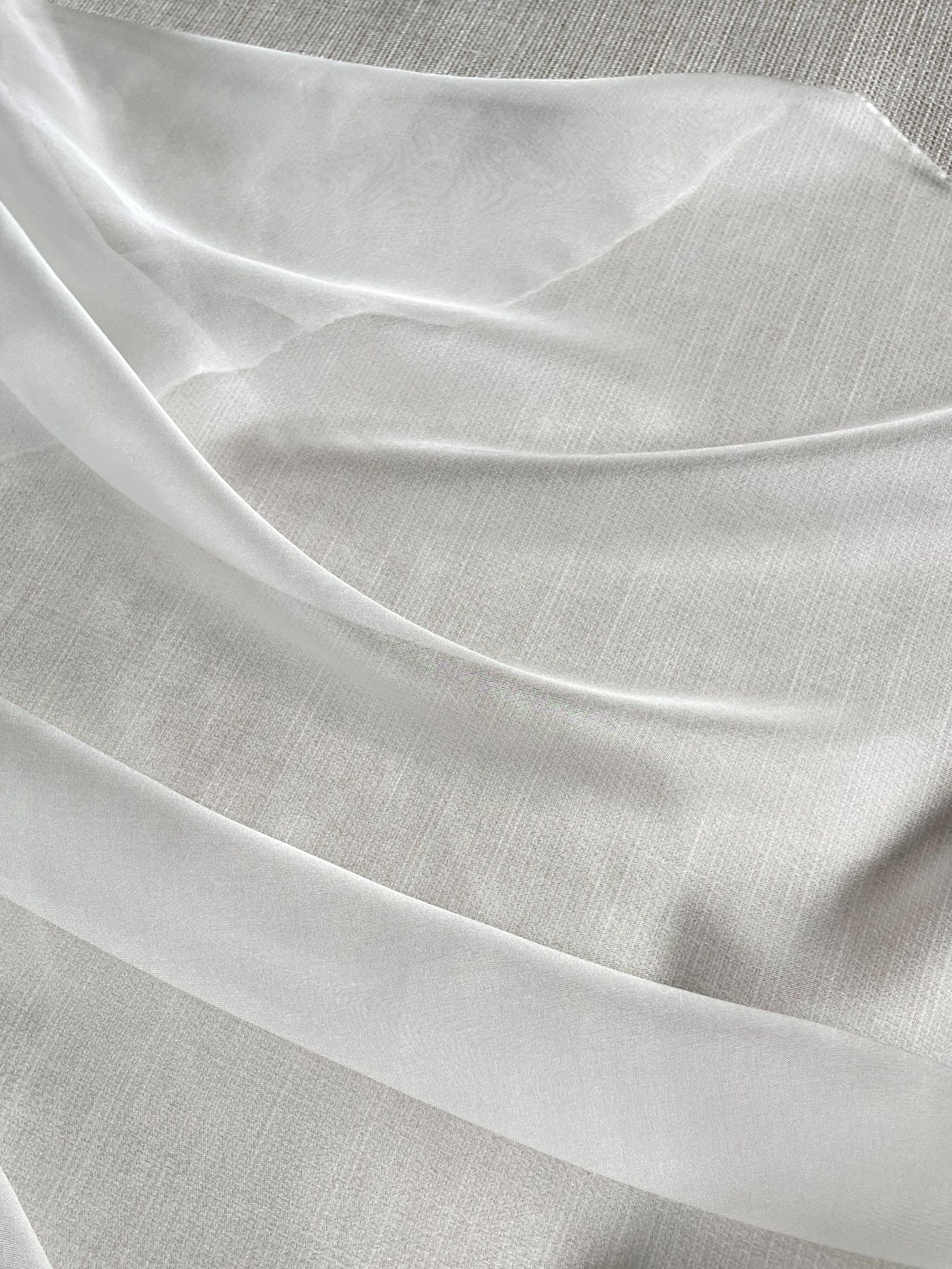 Close-up of Undyed Silk Chiffon fabric in transparent folds with a subtle texture