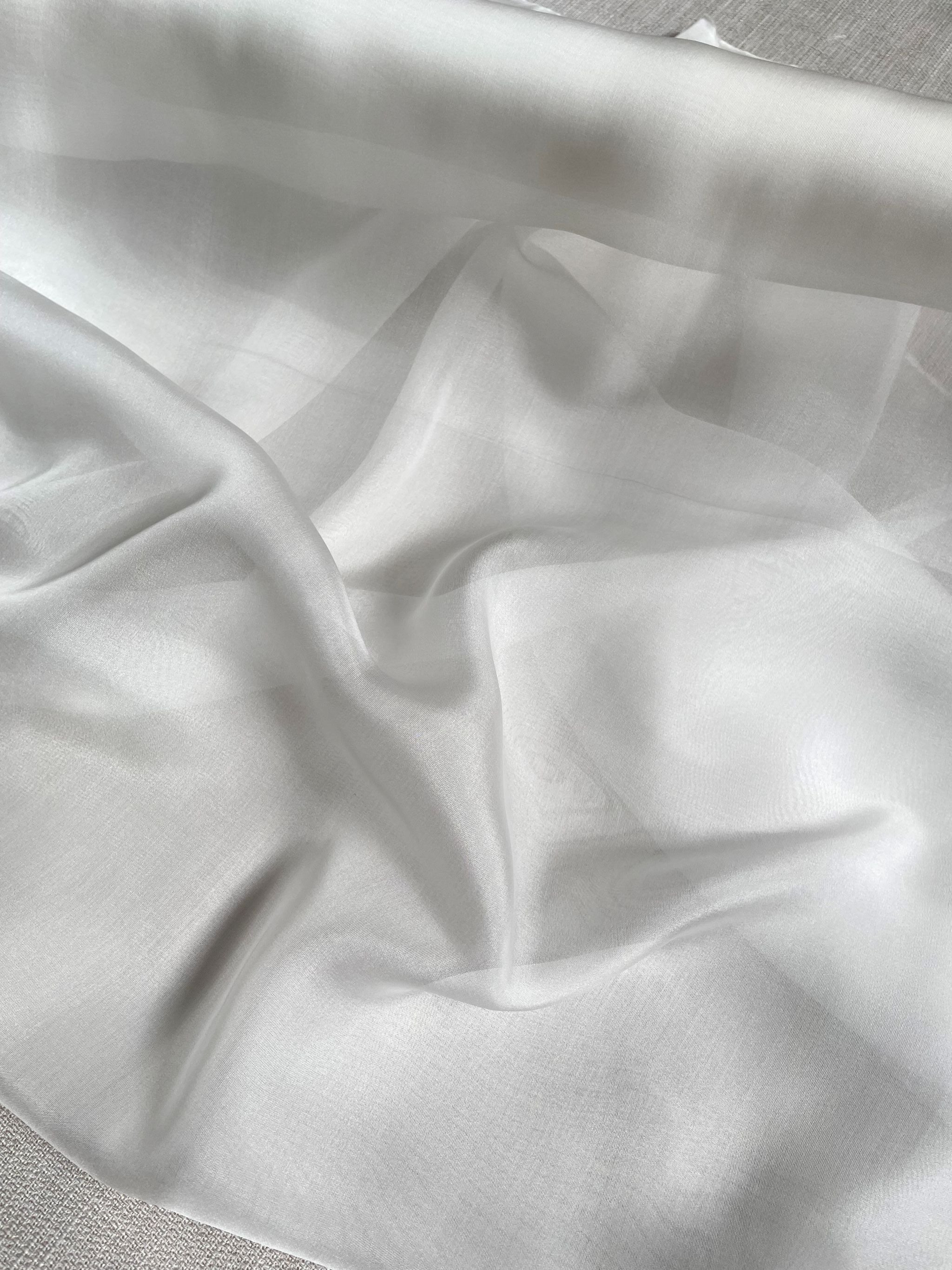 Close-up of undyed silk Chiffon fabric with folds