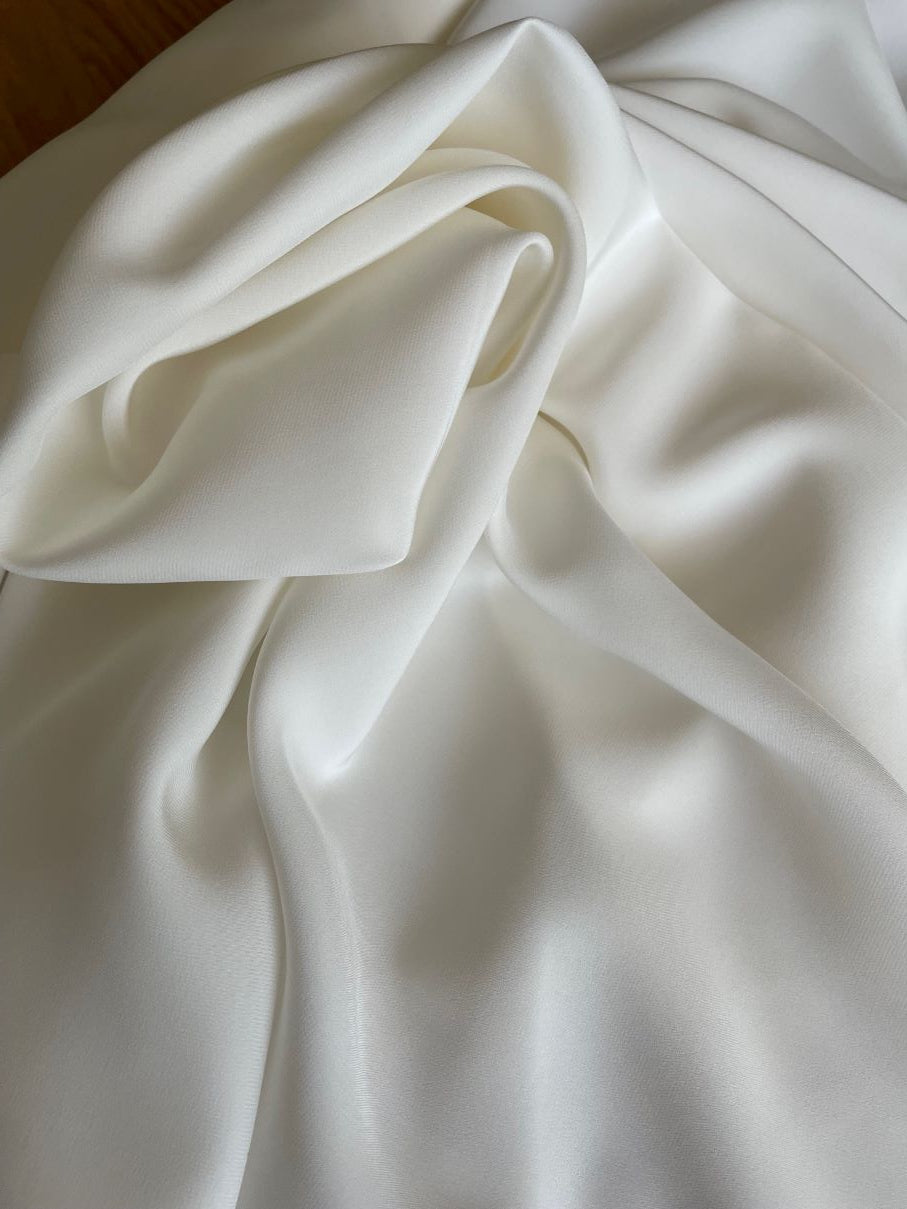 Close-up of silk satin crepe fabric with folds showing matte side