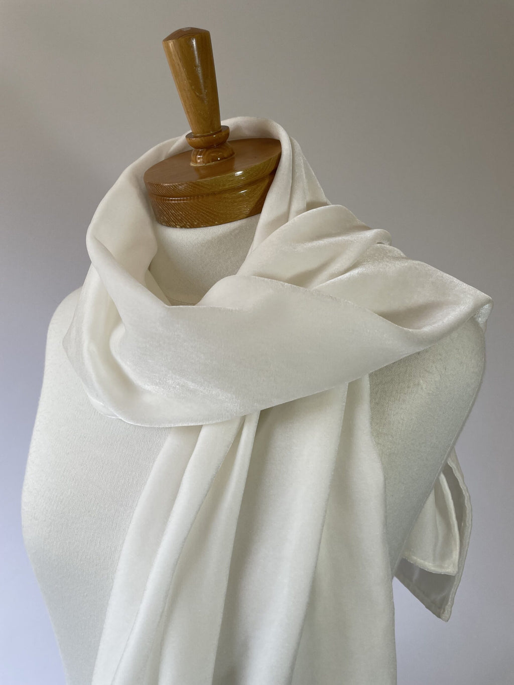 Undyed Viscose Velvet Scarf draped over a wooden mannequin against a plain background