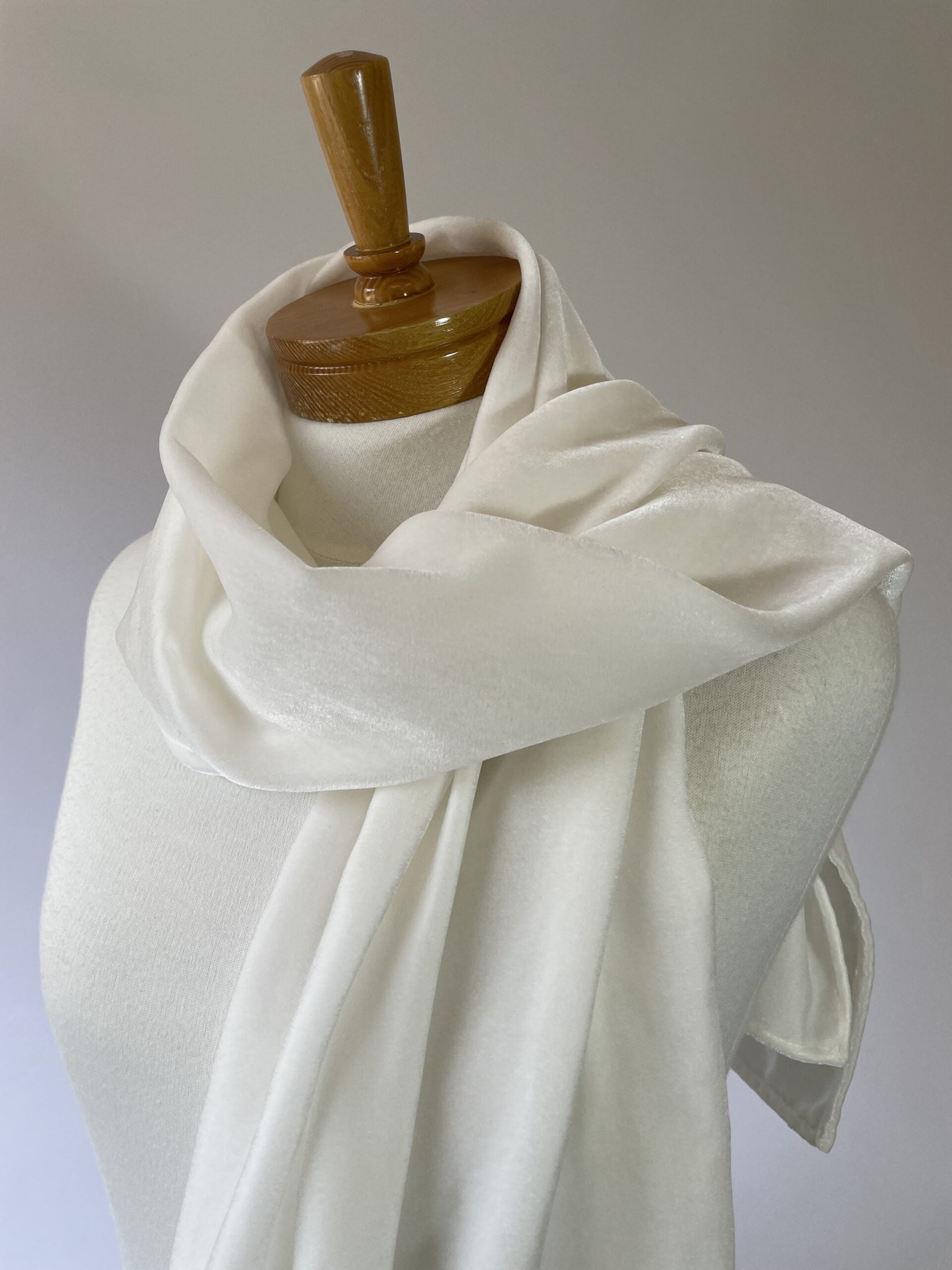 Undyed Viscose Velvet Scarf draped over a wooden mannequin against a plain background