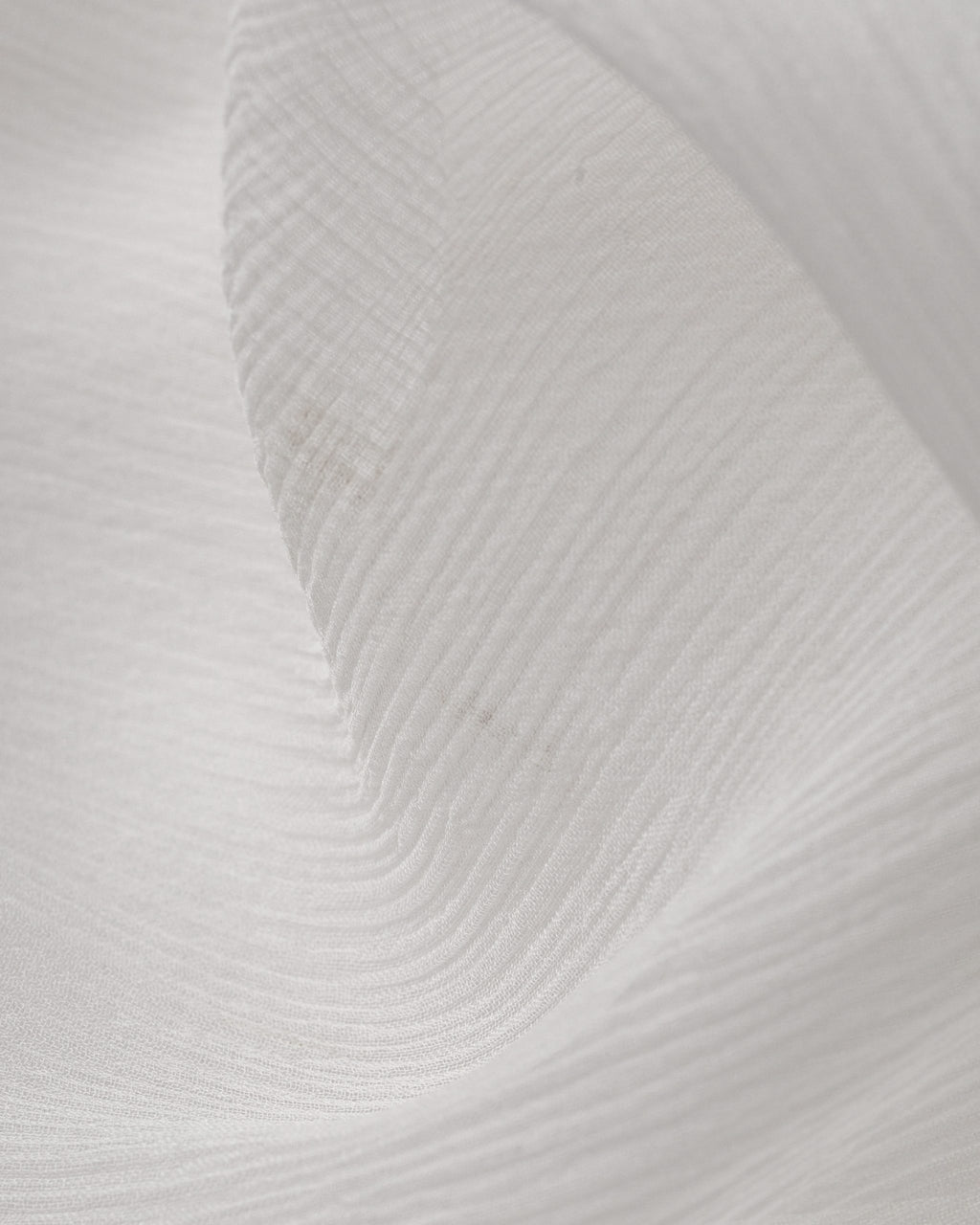 Close-up of textured undyed crinkle chiffon silk fabric