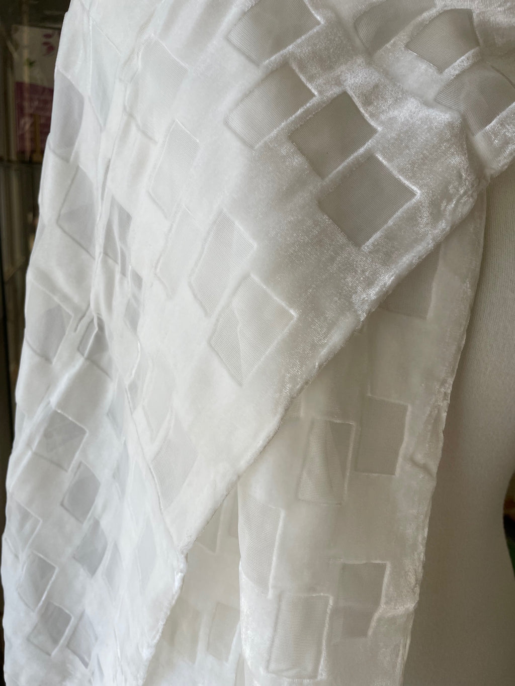 Undyed devore silk scarf textured with geometric pattern on a plain background