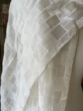 Undyed devore silk scarf textured with geometric pattern on a plain background