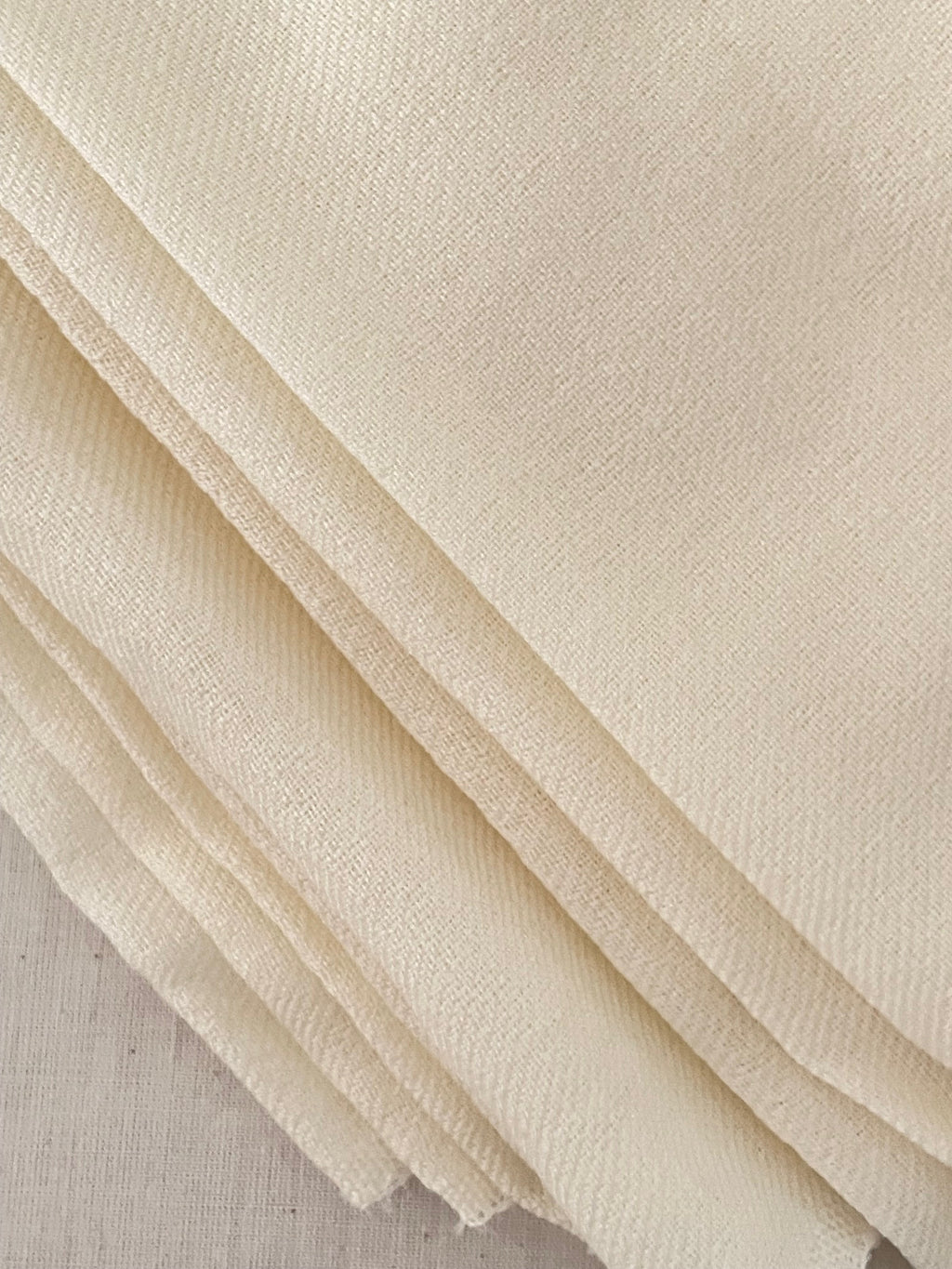 Close-up of Undyed lightweight wool fabric with a subtle texture