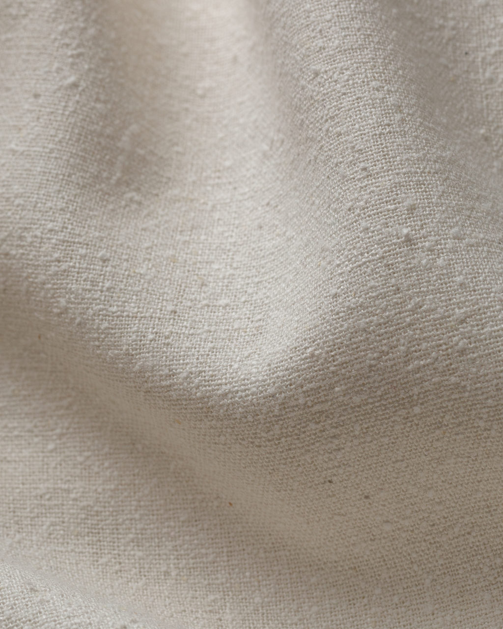 Close-up of undyed silk noil fabric texture