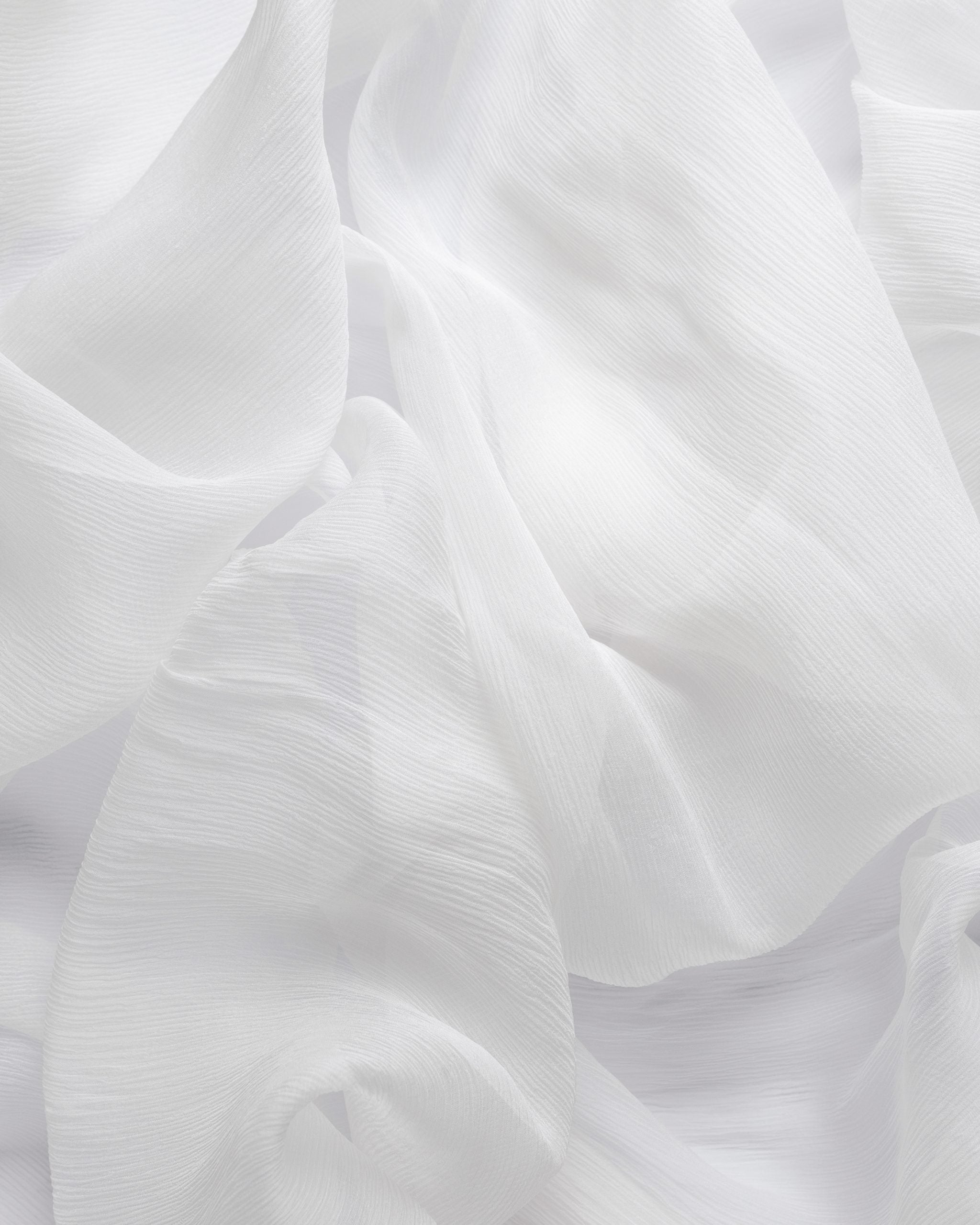 Close-up of undyed silk crinkle chiffon fabric with ruffled texture