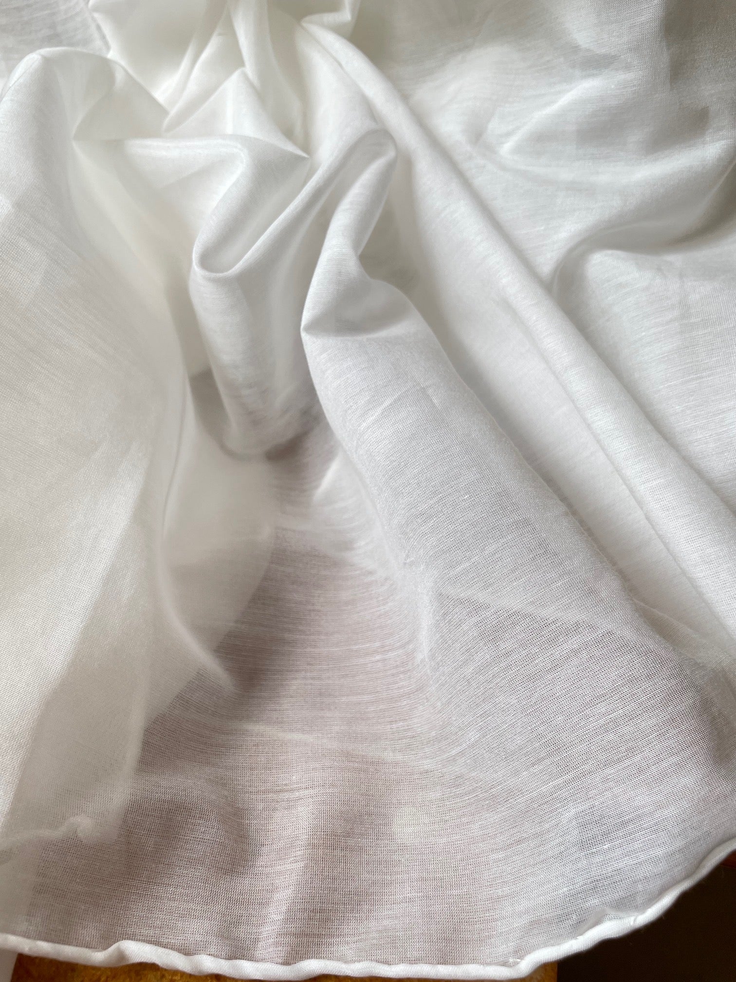 Close-up of undyed white silk cotton scarf with folds