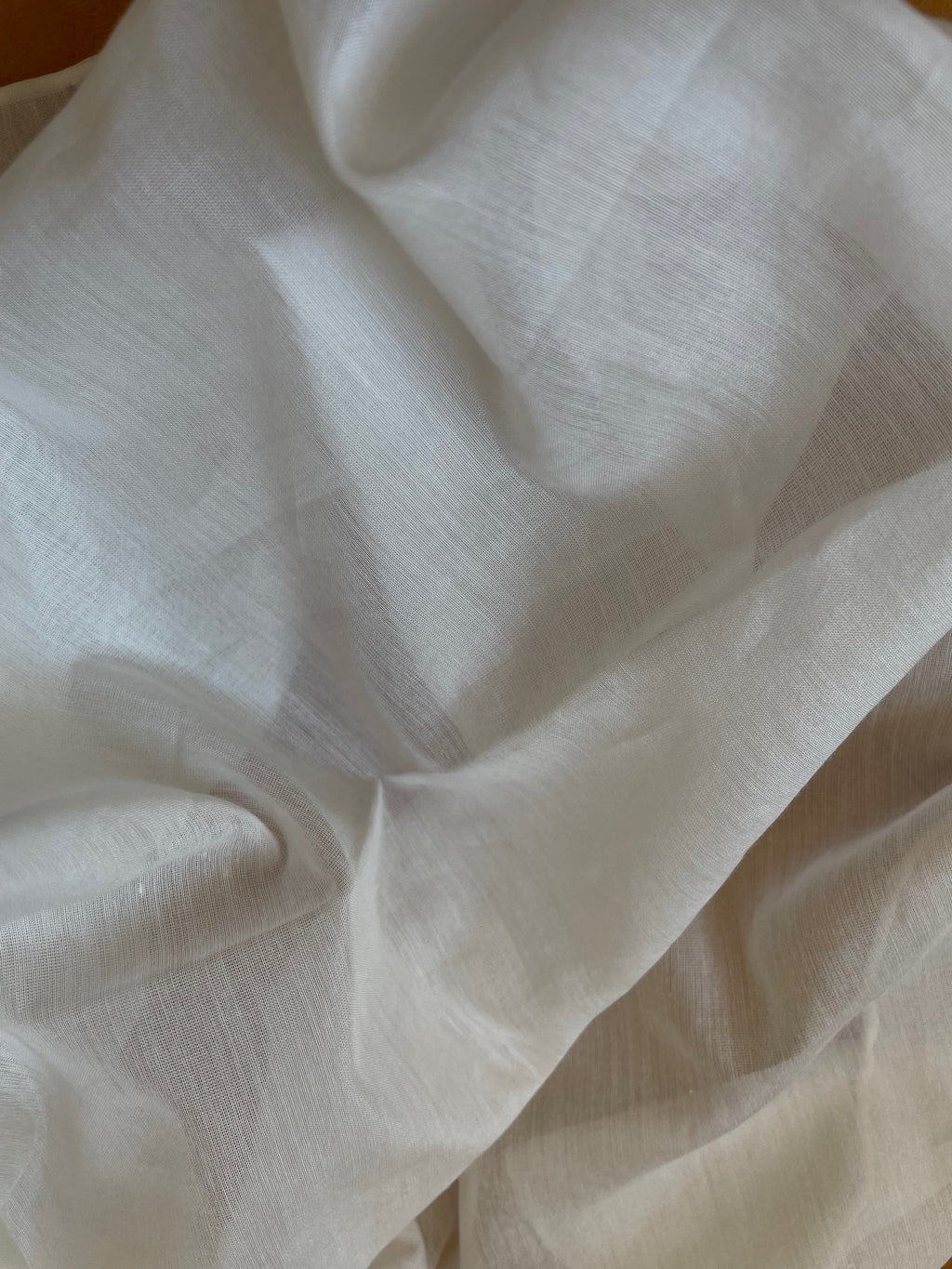 Close-up of undyed silk cotton voile  fabric with folds