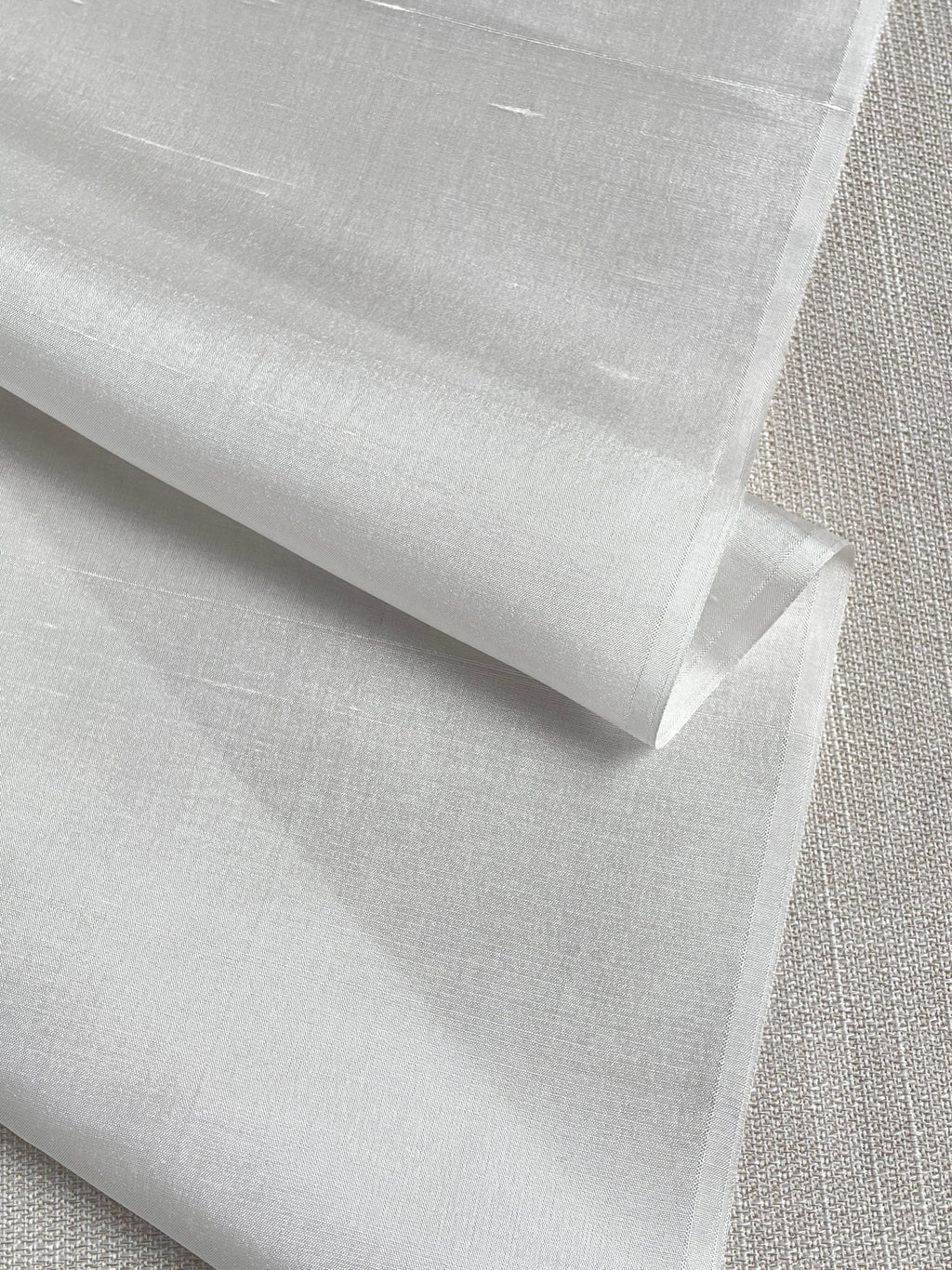 undyed silk dupioni fabric with a textured surface on a gray background