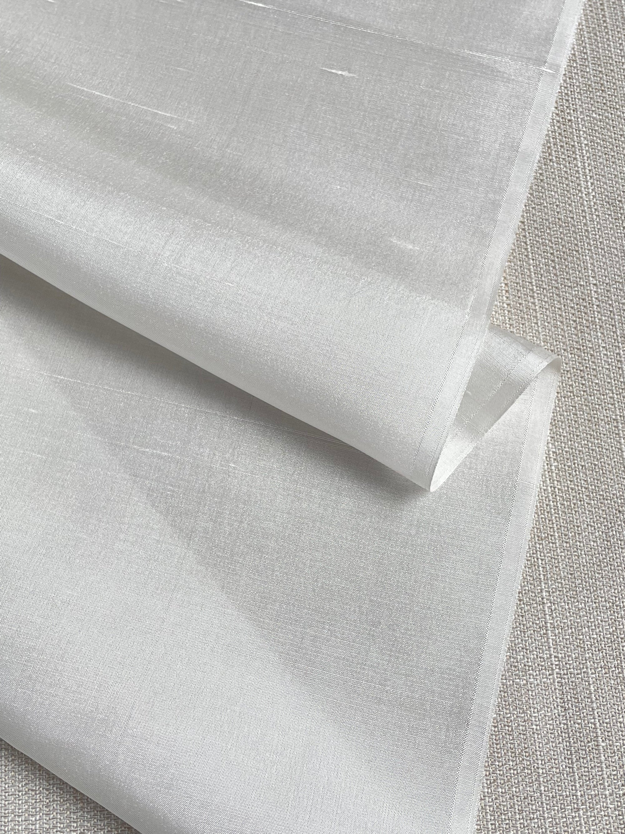undyed silk dupioni fabric with a textured surface on a gray background