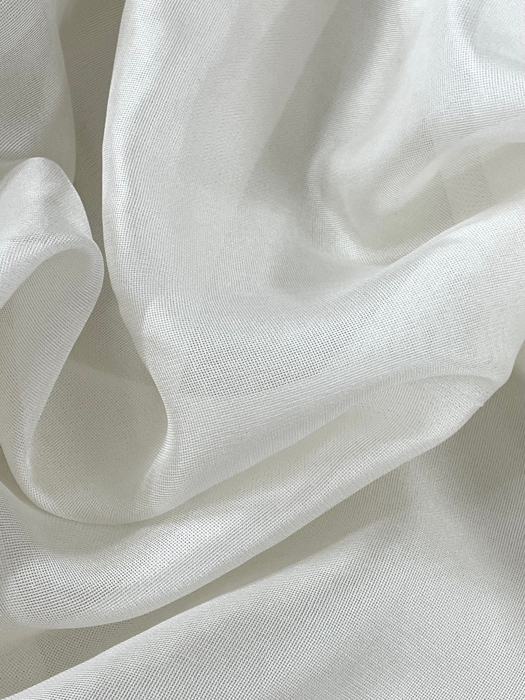 Close-up of white silk mesh fabric with soft folds
