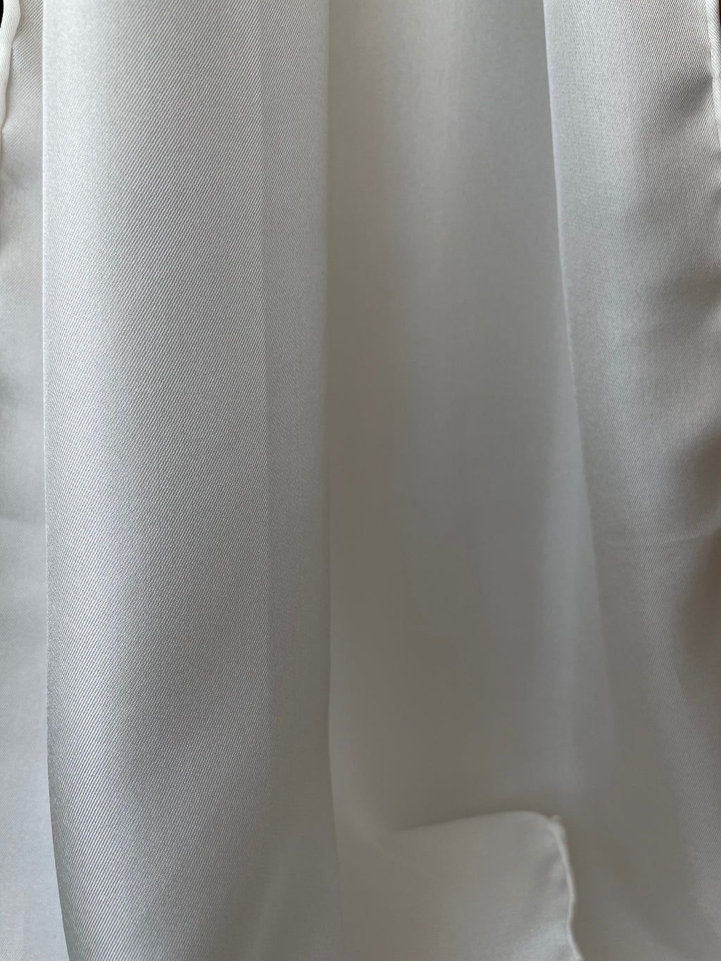 Close-up of undyed silk twill textured fabric