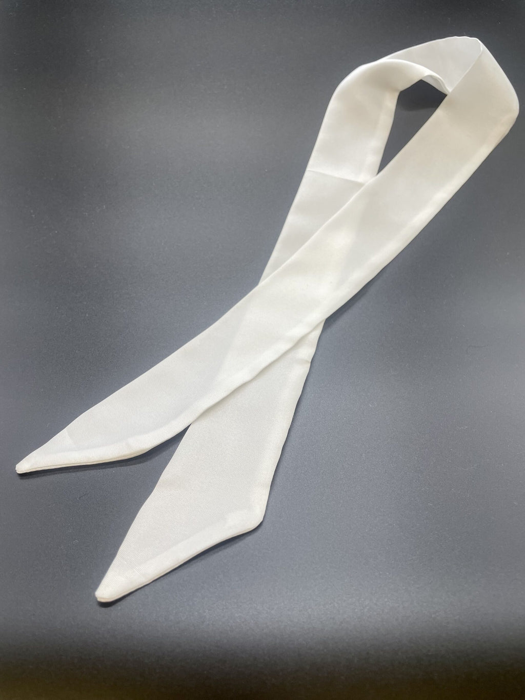 Undyed silk twill twilly scarf flat on a gray background