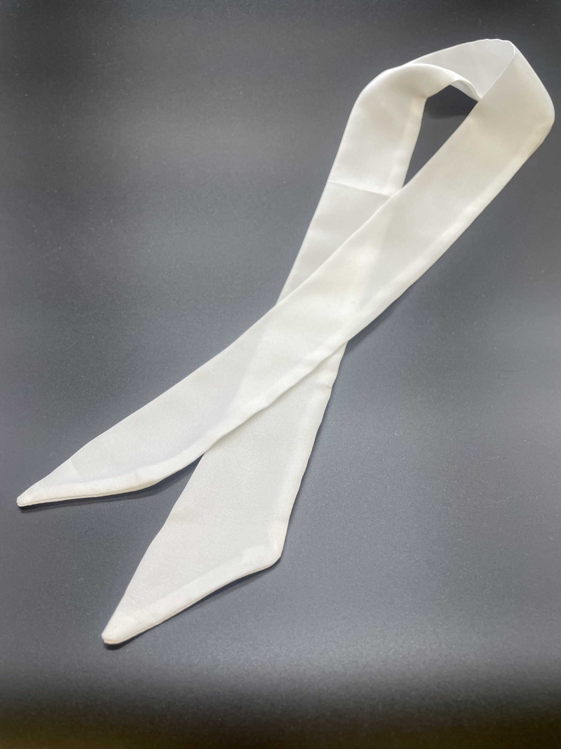 Undyed silk twill twilly scarf flat on a gray background
