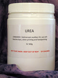 Container of urea powder with text on a purple background