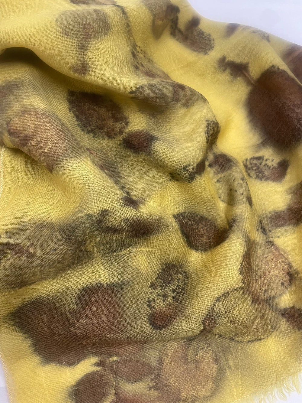 Textured yellow fabric with brown and black pattern