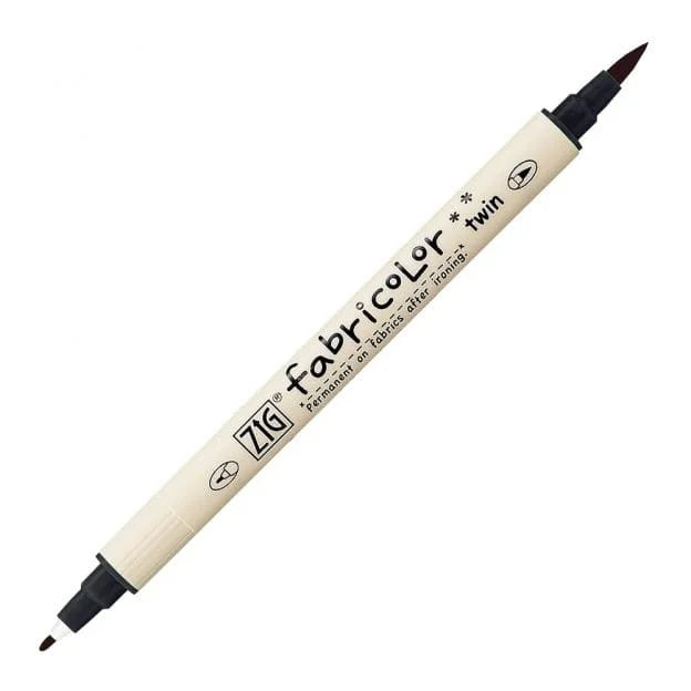 A ZIG fabric color twin-tip marker with a cream-colored barrel and black tips, shown diagonally on a plain white background.