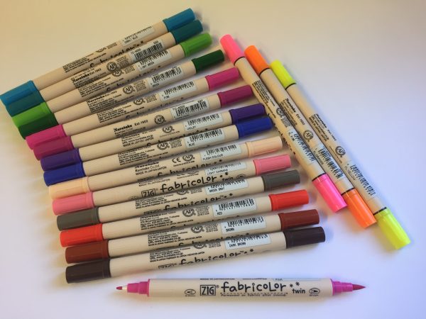 Set of Fabricolor markers in various colors on a white background